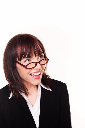Laughing businesswoman looking up over the top of her glasses or spectacles into blank copyspace above her headの写真素材