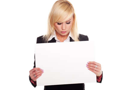Professional blonde woman holding a blank signboard and looking down to see your message or textの写真素材