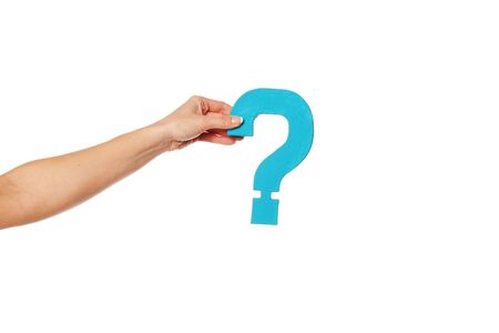 Female hand holding up a turqise question mark against a white background conceptual of questions, query, why or what.の写真素材