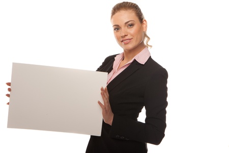 Attractive blonde business woman in dark suit holds a blank whit card with space for your textの写真素材