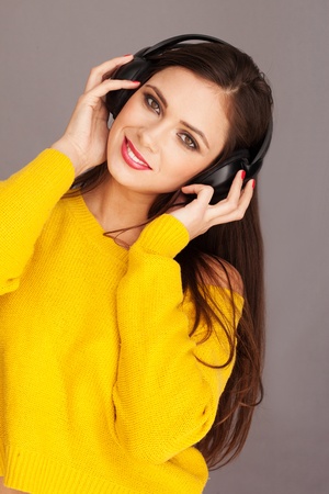 Happy woman listening music with her headphoneの写真素材
