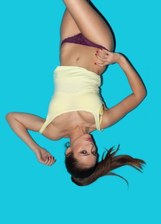 Portrait of sensual woman lying on a blue backgroundの写真素材