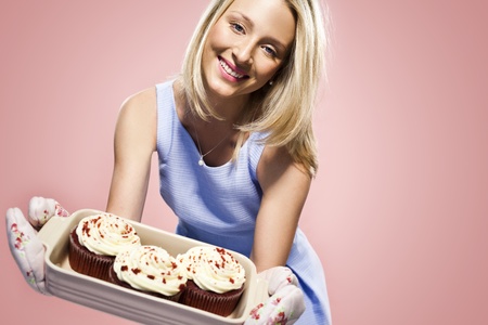 Beautiful sexy young woman  holding cupcakes の写真素材