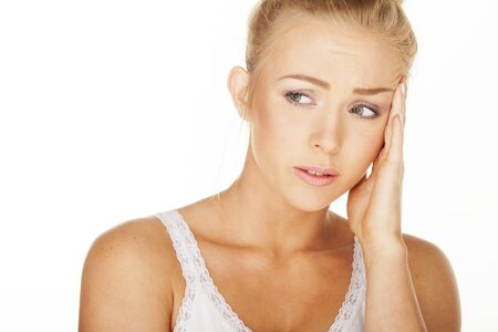 Sexy woman on white have a headache の写真素材