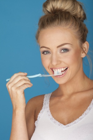 Sexy woman on blue brushing here teeth の写真素材
