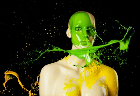 yellow and green paint splashes on manekin head