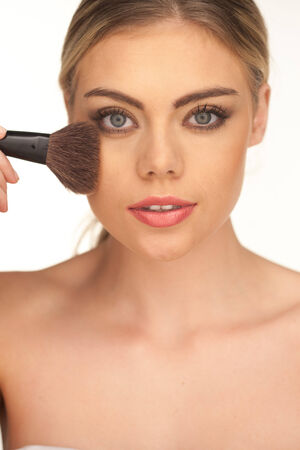 Closeup portrait of young beautiful girl with perfect skin and curly hair  Powder and foundation make up by soft brushの写真素材