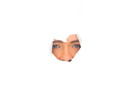 face of the man on the paper holeの写真素材