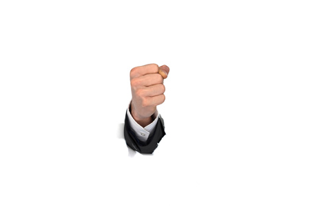 businessman hand fist breaking through white paper wallの写真素材