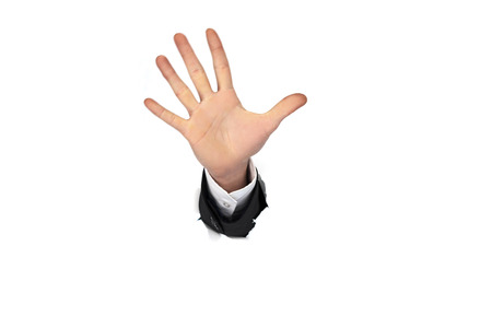 business man hand in the paper whole whiteの写真素材