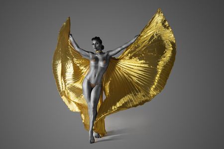 Half Naked Woman in gray bodypaint Spreading Her Golden Wings.の写真素材