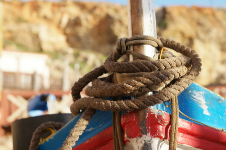 Close up Old Brown Rope Tie on a Vintage Boat at the Dock.