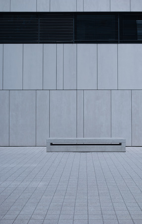 Single Empty Long Bench with Simple Design Against White Wall with Copy Spaceの写真素材