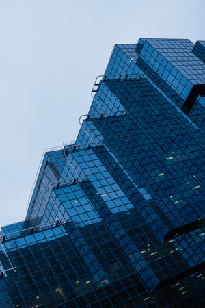 Perspective and underside angle view to textured background of contemporary glass building skyscrapersのeditorial素材