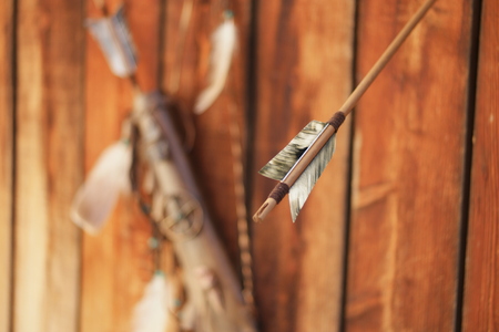tribal native american bow with feathers backgroundの写真素材