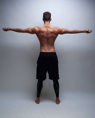 male model with muscular back on greyの写真素材