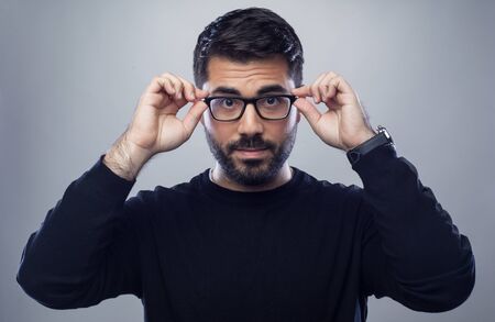 happy male business man holding his glasses