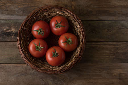 Fresh, ripe tomatoes on an old wooden board table?の写真素材