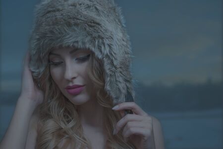 pretty brunette woman in warm winter hatの写真素材