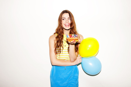 pretty birthday girl with ballons and cakeの写真素材