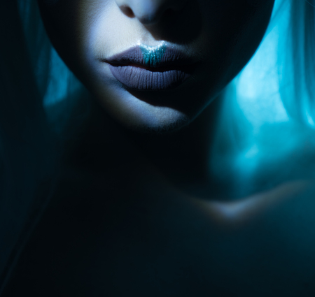 beauty lips with atmospheric light effect comming out of the dark , blue lips with greyの写真素材