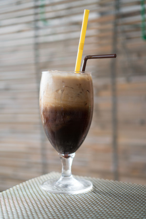 two iced coffee with milk in glass with strawsの写真素材