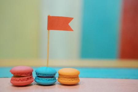 Multicolored macaroons on white wooden background. . Macaron or Macaroon is sweet meringue-based confectionの写真素材