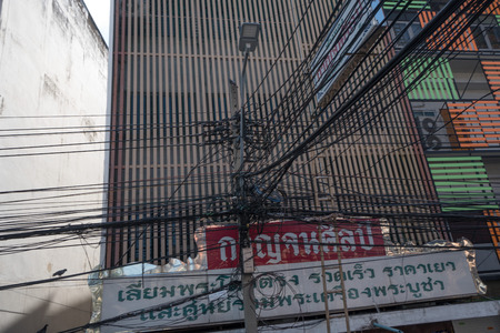 Tangled and messy electrical cables in Bangkok city, Thailandのeditorial素材