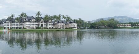 Lovely view of the lake near luxurious tropical resort over cloudy sky during dayのeditorial素材