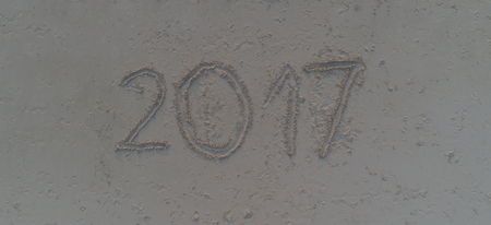 Year 2017 written on sand of tropical beach. Travel 2017 new year conceptの写真素材