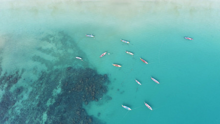 Aerial view of long tail boats on the sea near Kata beach in Phuket, Thailand