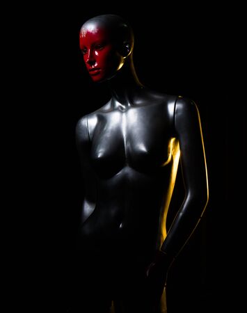 Silver female fashion mannequin with red face over black backgroundの写真素材