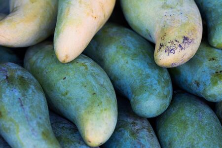 Closeup of fresh Mangoes fruit at the outdoor street food marketの写真素材