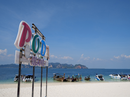 Colorful Poda island sign on the sandy beach over blue sea and sky backgroundのeditorial素材