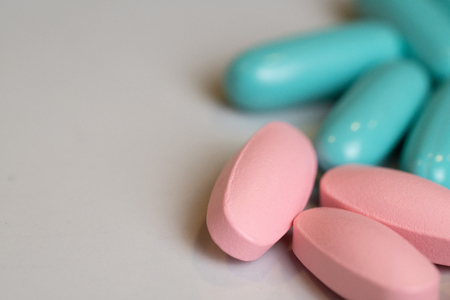 Macro closeup of herbal pills capsules on white table