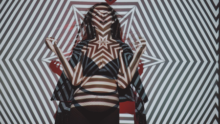 Portrait of woman in lingerie and jacket posing with projected pattern on her. Music, nightclubs, shows and entertainment conceptの写真素材