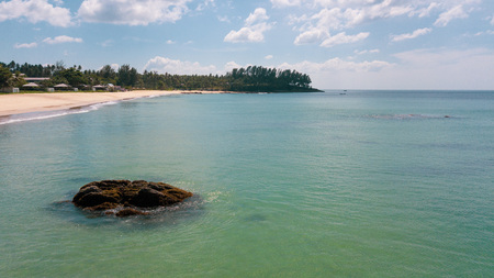 Aerial drone view of sea ocean water and beautiful tropical beach over summer sky backgroundの写真素材