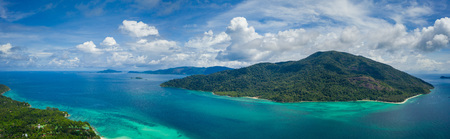 Aerial drone view of beautiful green Koh Usen island with amazing lagoon sea over summer sky...