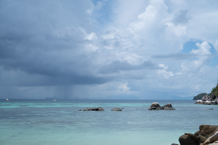 Turquoise sea with rocks over cloudy sky. Koh Lipe island in Thailandの写真素材
