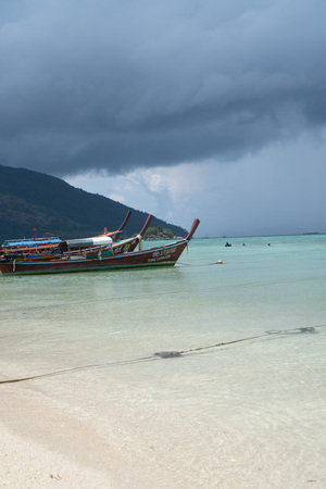 Sandy beach and sea with boats over cloudy sky. Koh Lipe island in Thailandのeditorial素材