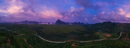 Aerial drone view of scenic tropical bay with limestone cliffs and rock formations during beautiful sunsetの写真素材
