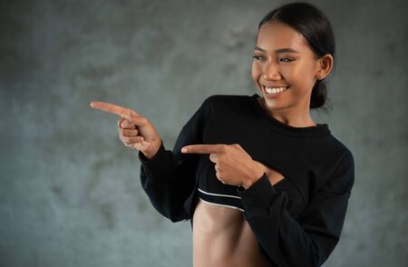Portrait of fitness beautiful and smiling female model posing at the fitness gym