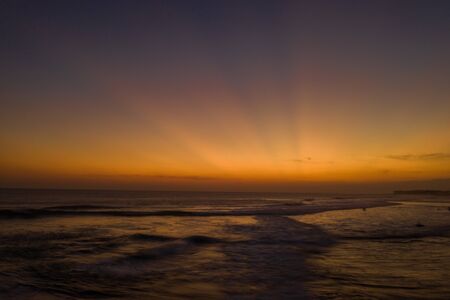 Aerial drone view of the sea over beautiful golden sunset sky backgroundの写真素材