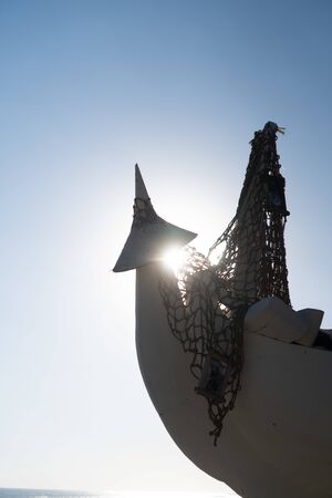 Part of boat with fish net, decor of beach club over blue summer sky backgroundの写真素材