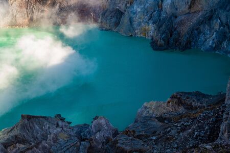 Aerial view of beautiful Ijen volcano with acid lake and sulfur gas going from crater, Indonesiaの写真素材