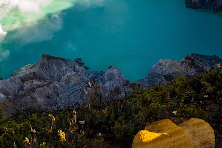 Aerial view of beautiful Ijen volcano with acid lake and sulfur gas going from crater, Indonesiaの写真素材