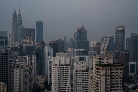 Aerial drone view of Kuala Lumpur city skyline during cloudy day, Malaysia