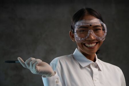 Portrait of female doctor nurse hospital worker over concrete wall backgroundの写真素材