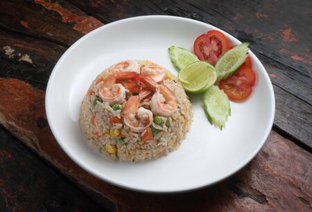 Top view Thai food shrimp fried rice isolated on rustic wooden tableの写真素材