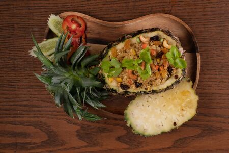 Top view Thai food pineapple chicken fried rice isolated on wooden table